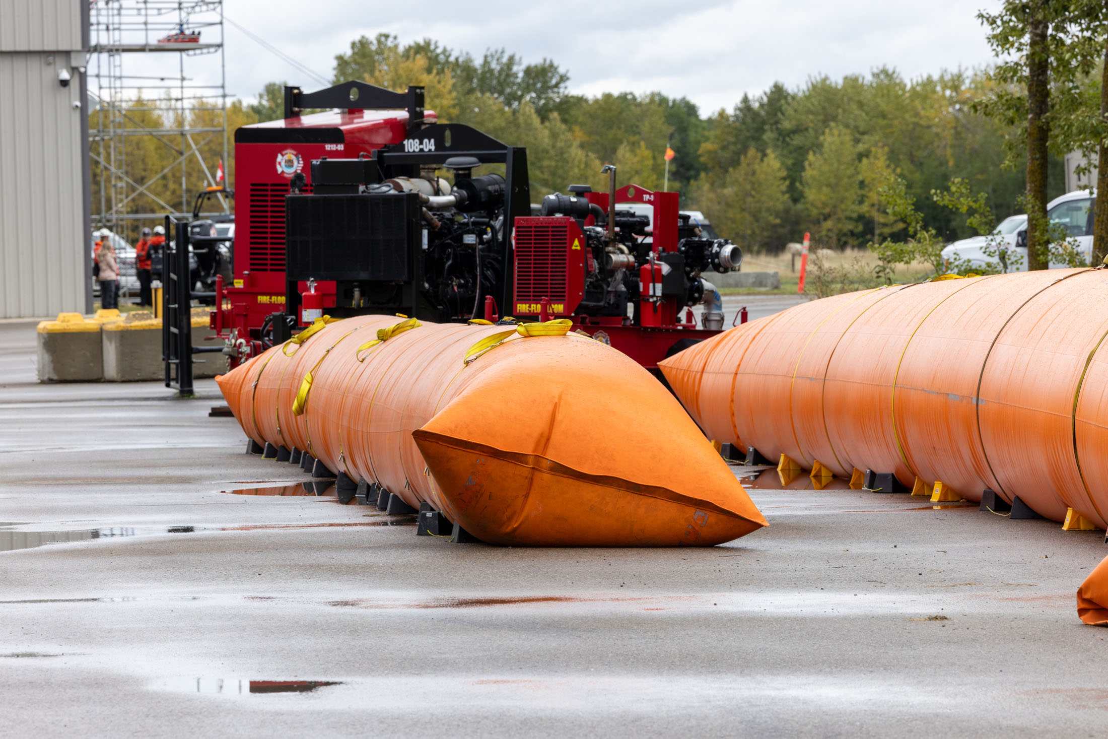 Orange inflatable flood barriers with fire pump equipment